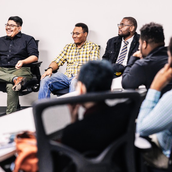 Group of men sitting at table talking