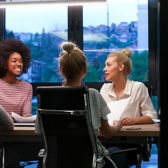 Group of young adults at board room table