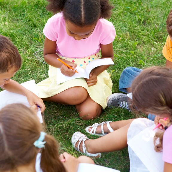 Group of children sitting on the grass