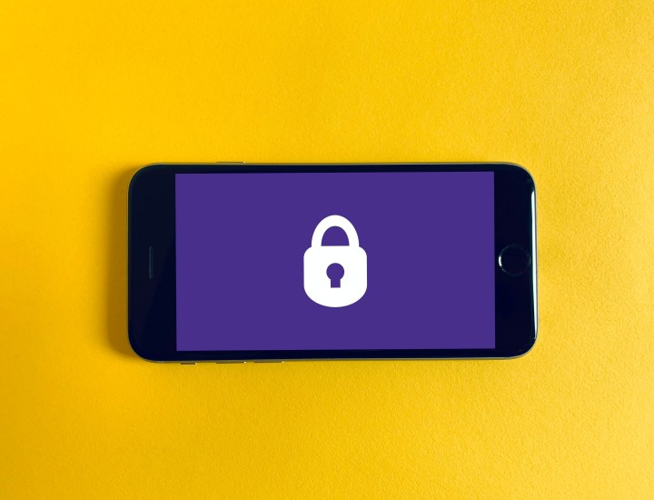 Yellow background, smart phone with purple screen and a white lock.