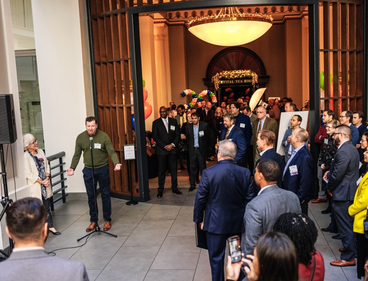 Group of event attendees listening to a speaker
