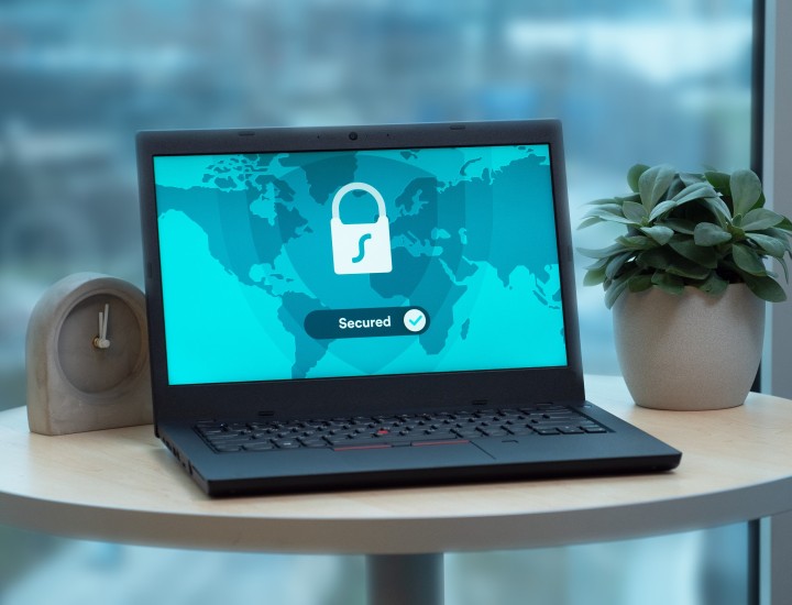 Laptop open to a secured screen with a lock on it and a map.